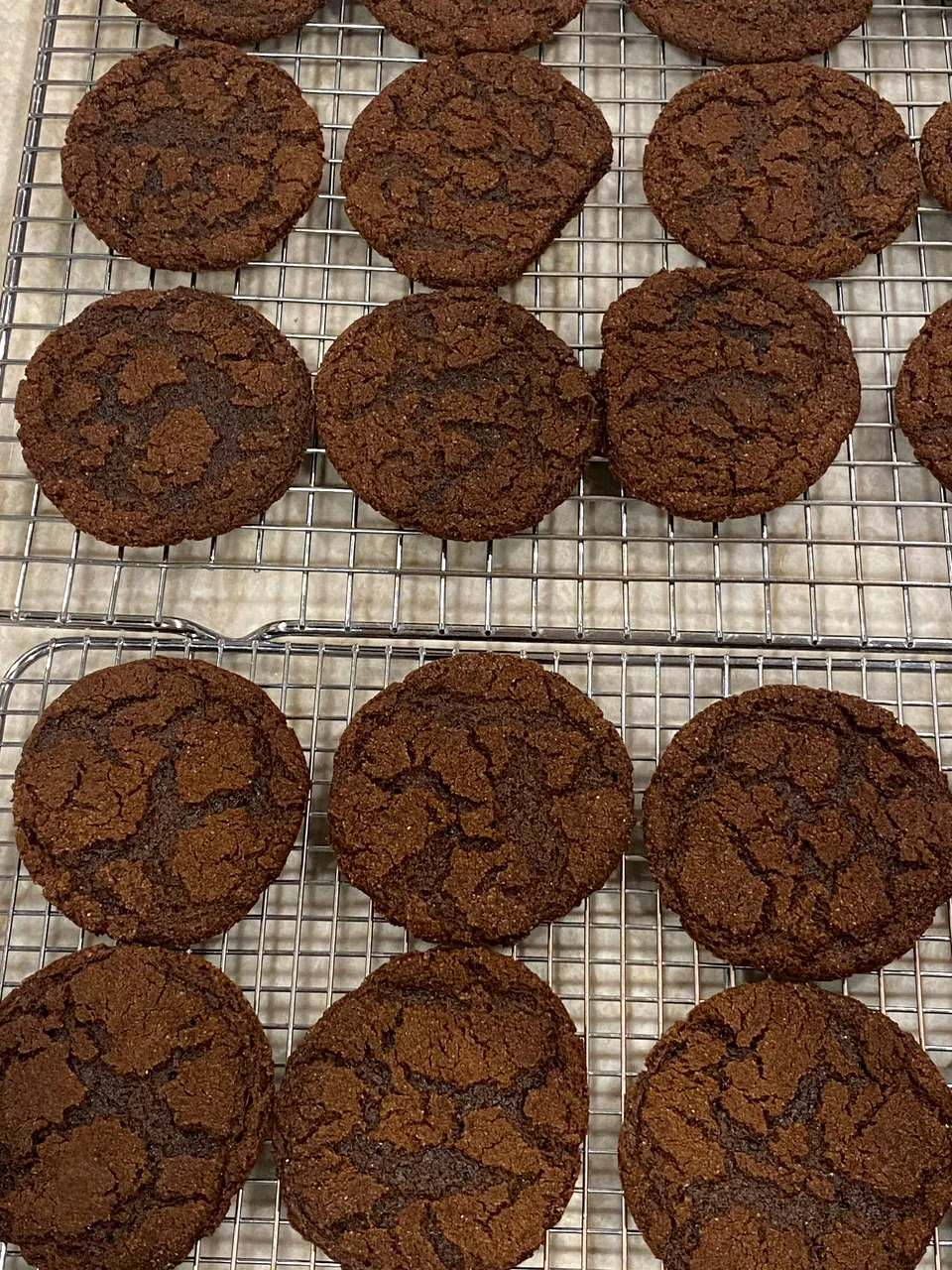 Dark chocolate cookies cooling on a rack