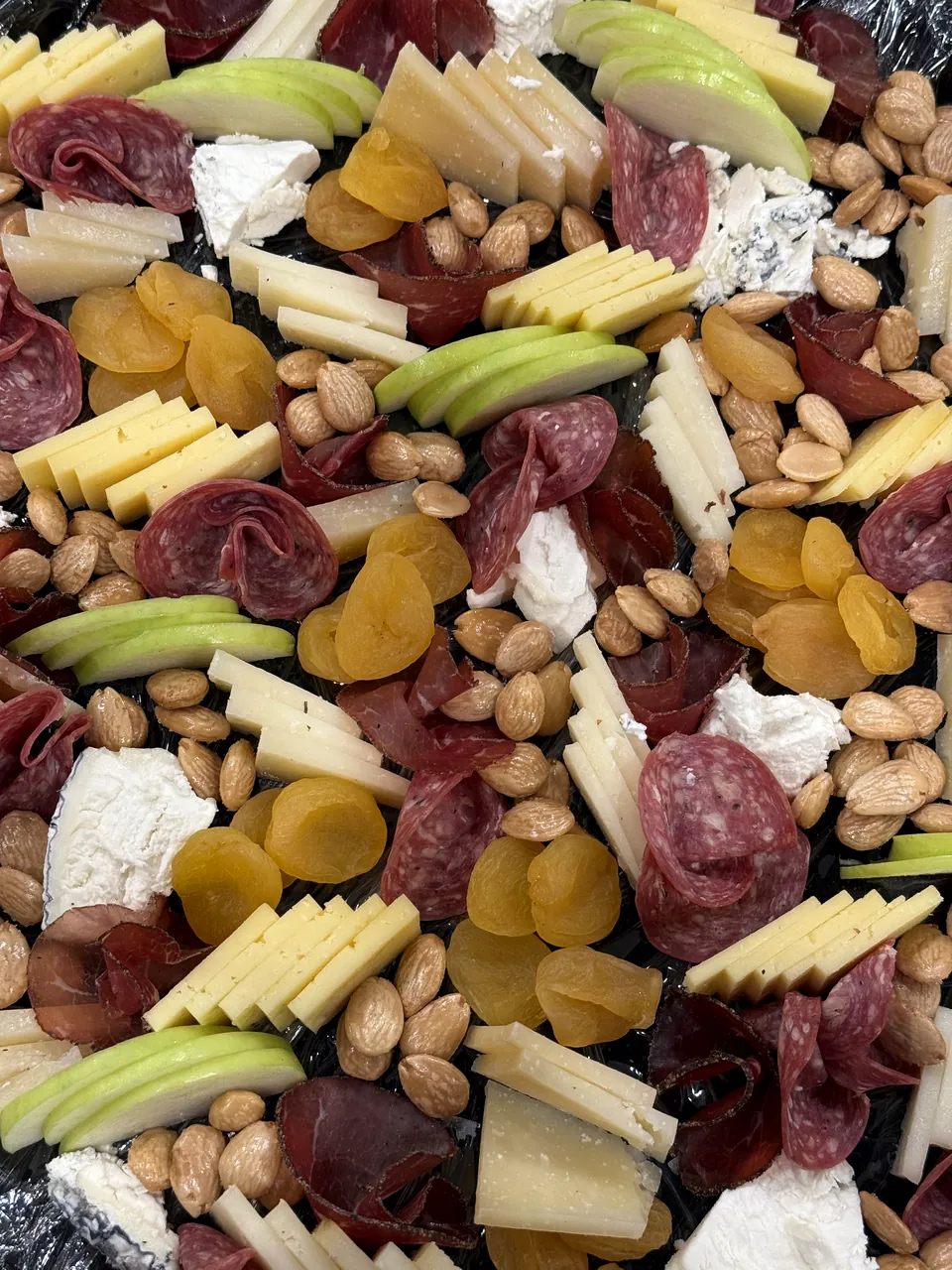 Board of cheese, charcuterie, fruit and almonds